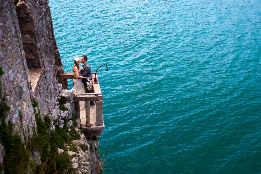 destination wedding lake garda malcesine castle italy bride groom water