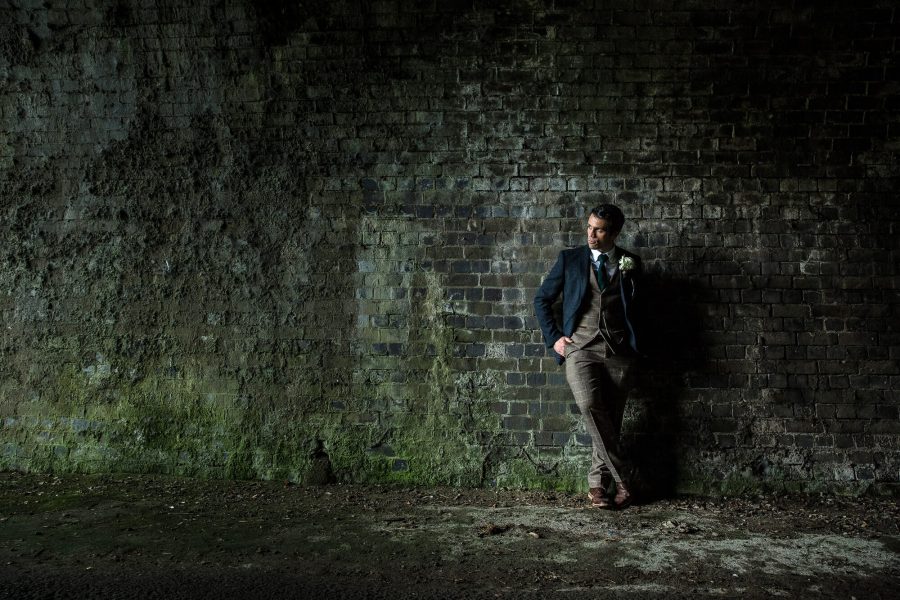 A groom in his suit in natural light by john fox wedding photography