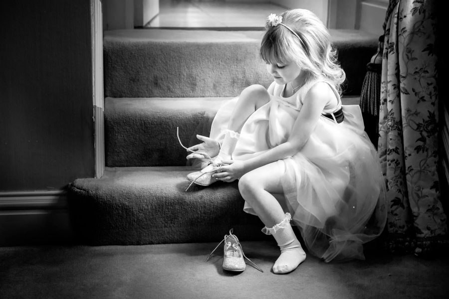 bridesmaid flower girl tying her laces by john fox wedding photography
